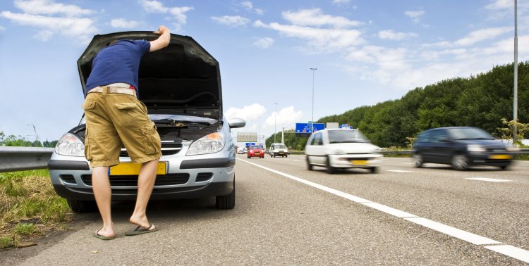 extended car warranty car by the side of the road man checking under the hood